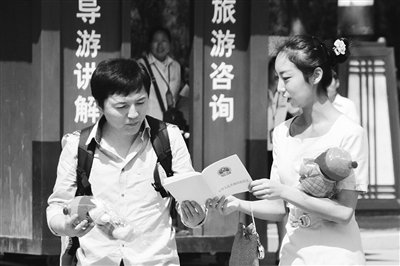 9月13日，西安臨潼華清池景區(qū)服務人員向游客介紹《旅游法》。
