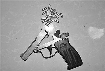 警方從搶劫嫌疑人處起獲的贓款和發(fā)令槍、子彈。警方供圖