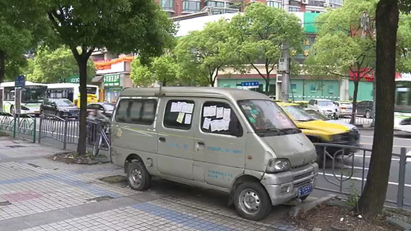 被棄置在人行道上的面包車。