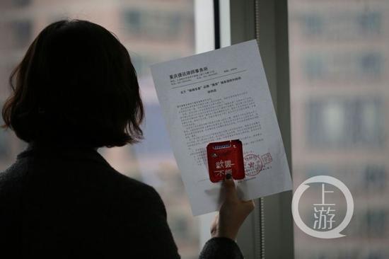 當事人出示律師函和神似避孕套包裝的辣條。上游新聞-重慶晨報記者 苑鐵力 攝