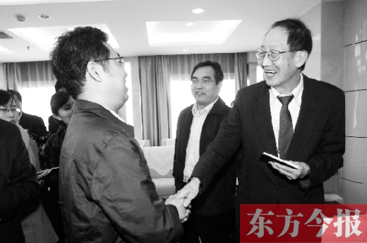 崔琦先生握手東方今報記者靳暉，感謝他把照片珍藏了15年